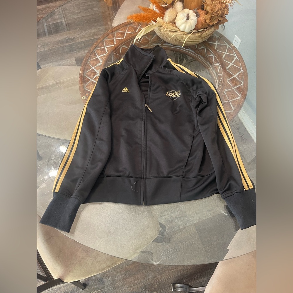 Woman’s Adidas Black and gold Los Angelas Lakers zip up jacket size Medium